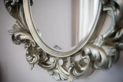an ornate mirror on a wall at Schloss Wartensee in Rorschacherberg