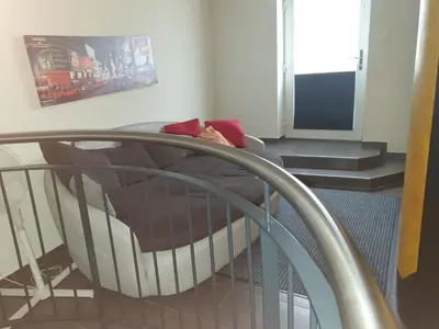 a bedroom with a bed and a staircase at Grosses Apartement 2 Schlafzimmer am Bodensee in Arbon