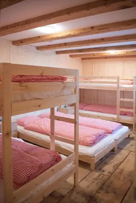 a group of bunk beds in a room at Restaurant und Kaeserei Berghof in Ganterschwil