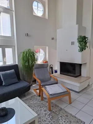 a living room with a couch and a fireplace at Zwinglis Ferienwohnung in Nesslau