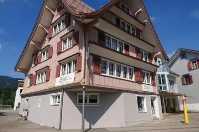 a large building with a brown and white at Zwinglis Ferienwohnung Klärli in Nesslau