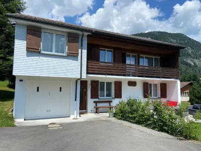 a house with two garage doors and a porch at Sonnhalde in Wildhaus