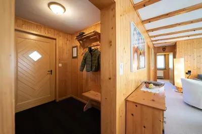 a room with a wooden door and a wooden table at Frühweid in Unterwasser