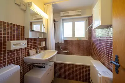a bathroom with a sink and a tub and a toilet at Frühweid in Unterwasser