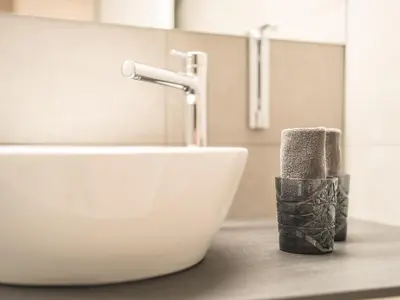a bathroom sink with a faucet on a counter at Traube Restaurant & Hotel in Appenzell