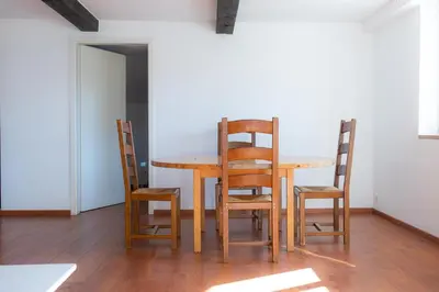 a dining room table and four chairs in a room at Säntisecho - in der Natur zu Hause in Urnäsch