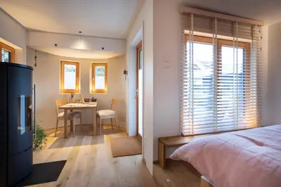a bedroom with a bed and a desk and a table at Logis Freyja in Landschlacht Gemeinde Münsterlingen