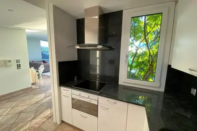 a kitchen with a black counter top and a window at Exklusive Mini-Villa mit viel Platz in Herisau