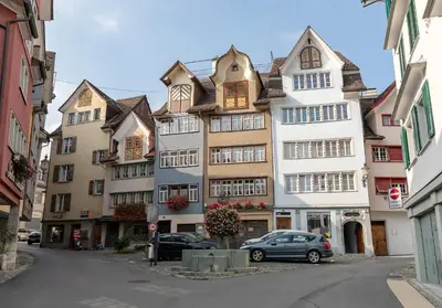 a tall building with a car parked in front of it at Hotel Untertor by Maier - Self-Check-in in Altstätten