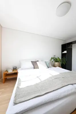 a white bedroom with a large white bed at Hotel Untertor by Maier - Self-Check-in in Altstätten