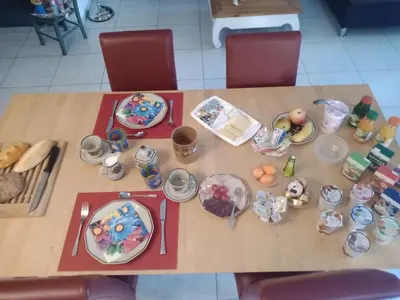 a wooden table with plates of food on it at B&B Im Bitzi in Zuzwil