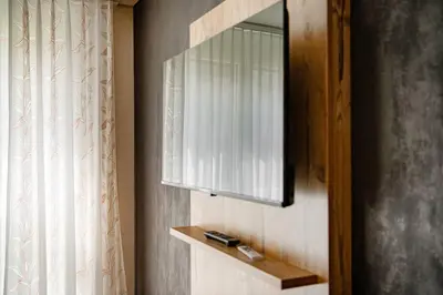 a mirror on a wall next to a window at Wohntel - wohnen wie im Hotel in Sevelen