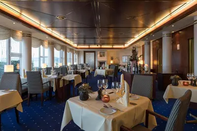 a dining room with white tables and chairs and windows at Bad Horn - Hotel & Spa in Horn