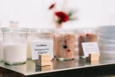 a group of jars of food on a shelf at Hotel Dom, zentral - herzlich - sozial engagiert in St. Gallen