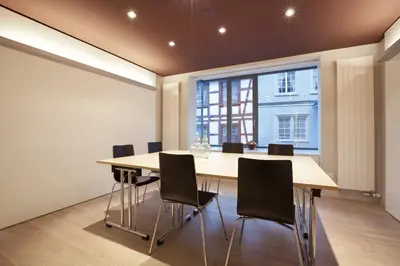 a conference room with a long table and chairs at Hotel Dom, zentral - herzlich - sozial engagiert in St. Gallen