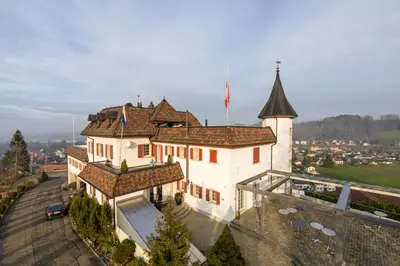 a building with a flag on top of it at Klein Rigi in Schönenberg