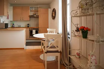 a kitchen with a table and chairs in a room at Lakeside Apartments Rorschach - easy self check-in in Rorschach