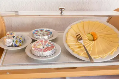 a tray with four plates of food on it at Hotel Metropol in Widnau