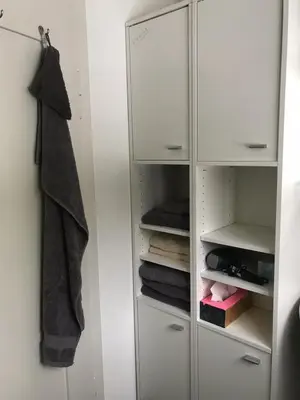 a white closet with white cabinets and towels at Appenzellerland - Ferienhaus 