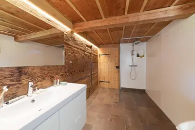 a bathroom with a white sink and a shower at Sigerst in Wildhaus