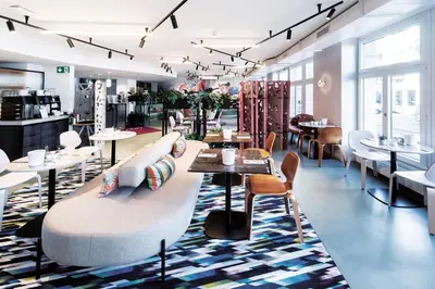 a restaurant with tables and chairs in a room at Sorell Boutique-Hotel City Weissenstein St Gallen in St. Gallen