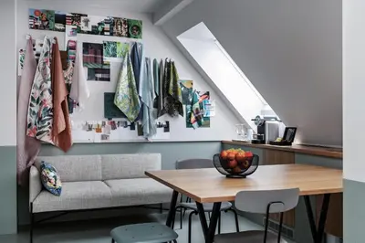a living room with a table and a couch at Sorell Boutique-Hotel City Weissenstein St Gallen in St. Gallen
