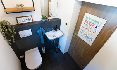 a small bathroom with a toilet and a sink at Ferienhaus Kluser in Oberriet