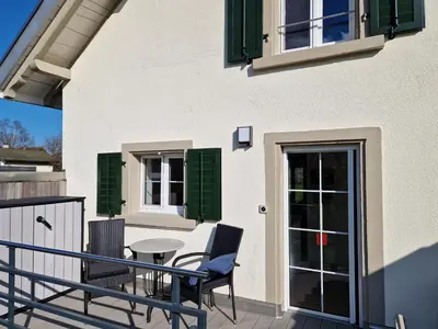 a patio with chairs and a table on a balcony at Ferienhaus Kluser in Oberriet