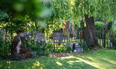 a garden with two chairs and a tree at Ferienhaus Kluser in Oberriet