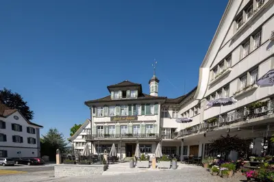 a large white building with a clock tower on top at Hotel Krone Gais in Gais