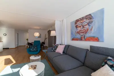 a living room with a couch and a painting on the wall at Panorama Blick in Unterwasser