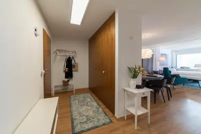 a living room with a hallway with a table and chairs at Panorama Blick in Unterwasser