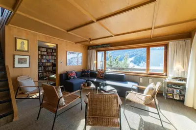 a living room with a blue couch and chairs at Etienne in Wildhaus