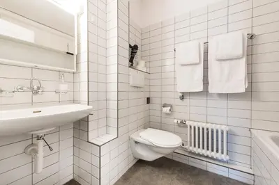 a white bathroom with a toilet and a sink at SOHO 1A !Gratis Parken, Free Parking! in Kreuzlingen