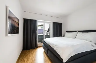 a bedroom with a bed and a large window at SOHO 1A !Gratis Parken, Free Parking! in Kreuzlingen