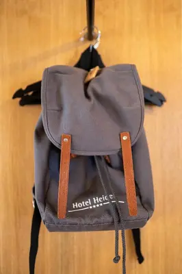 a backpack is hanging on a wall at Hotel Heiden - Wellness am Bodensee in Heiden