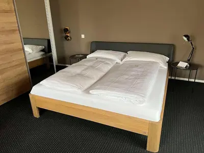 a bed with white sheets and pillows on it at Best Western Hotel Rebstock in Rorschacherberg