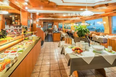a restaurant with two tables and a buffet at Best Western Hotel Rebstock in Rorschacherberg