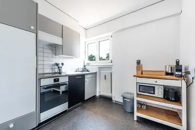 a kitchen with white appliances and a window at SOHO 9 !Gratis Parken, Free Parking! in Kreuzlingen