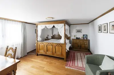 a table with a white table cloth in a room at Hotel Säntis in Appenzell