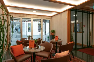 a restaurant with chairs and tables and windows at Hotel Löwen in Appenzell