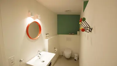 a bathroom with a sink and a mirror and a toilet at Alte Metzg - Hostel in Appenzell