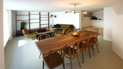 a kitchen and dining room with a wooden table and chairs at Alte Metzg - Hostel in Appenzell