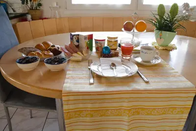 a wooden table with breakfast food on top of it at BNB Claudia in Appenzell
