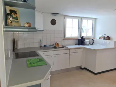 a kitchen with white cabinets and a sink at Alpen-Paradies Edelweiss in Urnäsch