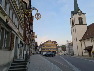 a city street with a building and a church at Alpen-Paradies Edelweiss in Urnäsch