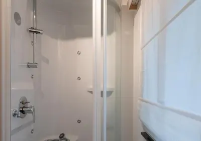 a bathroom with a shower and a sink at INN JOY Apartments - Sankt Gallen West in St. Gallen