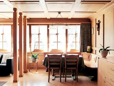 a dining room with a table and some windows at Gasthaus Hof in Appenzell