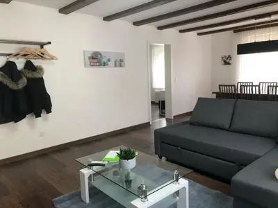 a living room with a couch and a table at INN JOY Apartments - Sankt Gallen Lachen in St. Gallen