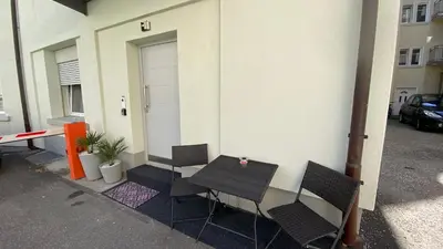 a table and chairs sitting outside of a building at Spielzimmer am Bodensee in Rorschach